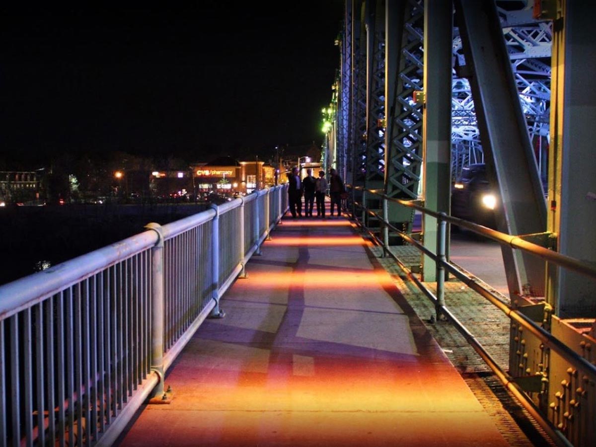 A fully lit bridge walkway after dark